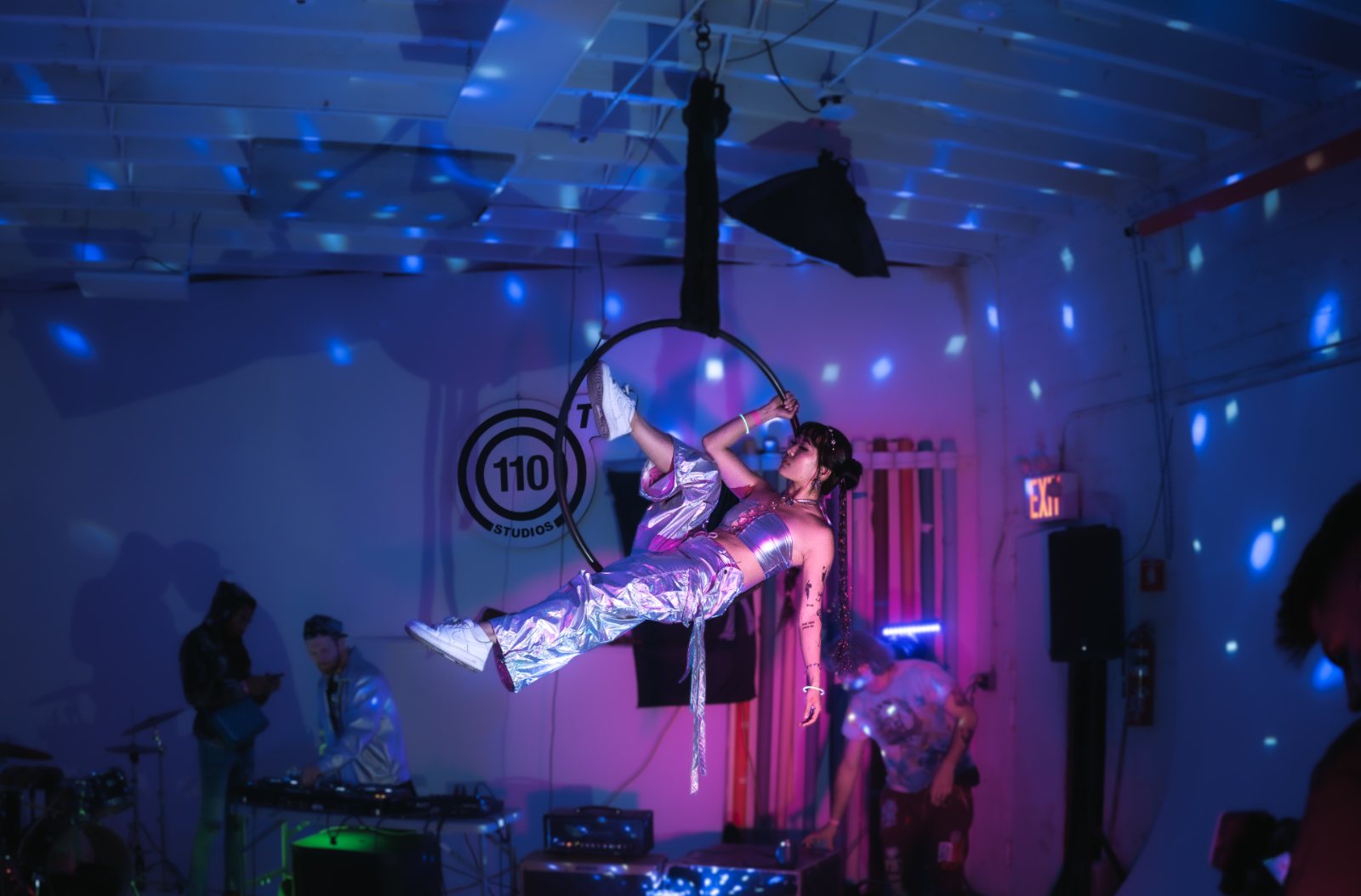 Aerial hoop performance under stage lighting at 110 Studios